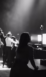 woman at end of a dance floor in front of a group of men