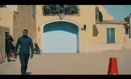 the two men are walking toward a building