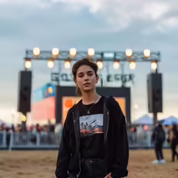 young woman standing in dirt with many lights