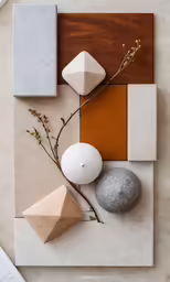 an arrangement with rocks, flowers and a candle