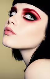 a woman with dark hair and red eyeliner