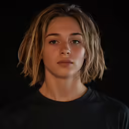 woman with a messy side part under her cheek