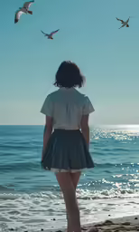 a woman standing on the beach watching seagulls flying over the water