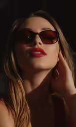 woman wearing sunglasses and leaning on her shoulder