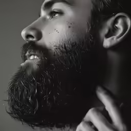a man with a beard is adjusting his collar