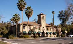 the building is tan and has green awnings