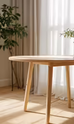 table with a plant in the middle near white curtains