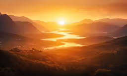 sunset over a mountain valley with the sun in the distance
