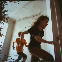 two young children run around in a hallway