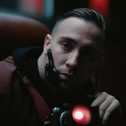 a young man is taking a picture with his camera
