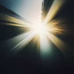bright sun lights up the sky from inside a moving train