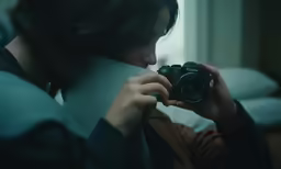 a woman is taking a photo with a camera