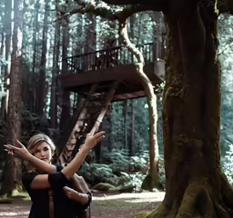 two women in the woods posing for a photo