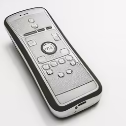 a silver cell phone laying on a white surface