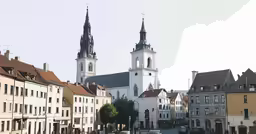 a row of buildings on the street with steeple tops