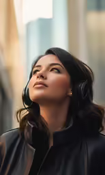 an attractive woman wearing headphones looking up