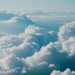 a cloudy blue sky with some clouds below