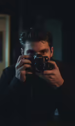 the young man is taking his own photograph in the mirror
