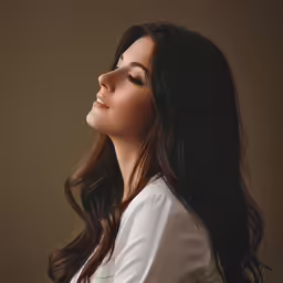 an attractive young lady with long hair looking off into the distance