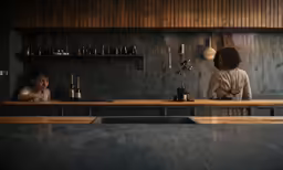 two people at a counter in a restaurant