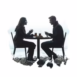 a couple sit at the table, with a view of the sea