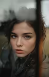 a woman with blue eyes is staring into the camera