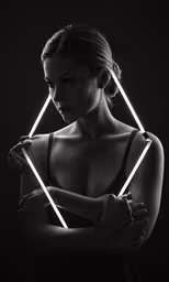 a woman with crossed arms in front of a black background