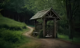 an empty wooden shelter sitting on a dirt path