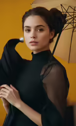 a woman standing in front of an umbrella with her arm around her waist