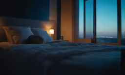 a person laying in bed with the lights on