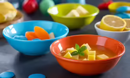 two bowls of fruit and other small containers of sweets