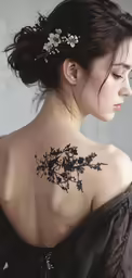 a girl wearing a floral tattoo on her back