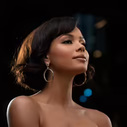 a woman with big earrings on her face looking up