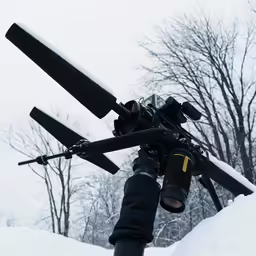 the camera is attached to the pole in the snow
