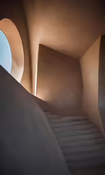 a staircase leading to a window in a building