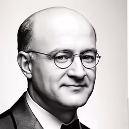 a man in glasses wearing a suit and tie
