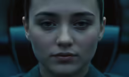 a woman with eye makeup looking directly into the camera