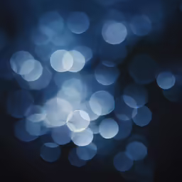 blue lights reflecting on a wet surface in the dark
