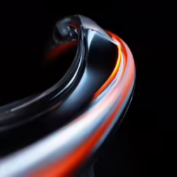 a close up shot of a metal surface with the bright red streaks