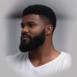 a close up of a young man with beard and white shirt