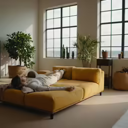 a person is lounging on a couch in a living room