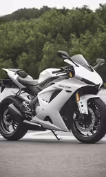 a white motorcycle is parked near some water