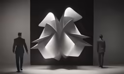 a couple of men standing in front of a display with paper sculptures