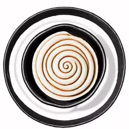 a swirl cookie is in a black round bowl
