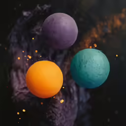 three balls of colored powder floating around on black background
