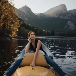 a woman sits on the side of her yellow boat