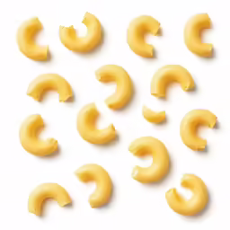 yellow macaroni - cheese slices are shown on a white surface