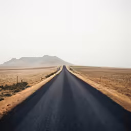 a long empty road stretches across the desert
