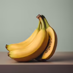 some bananas on a table and one ripe
