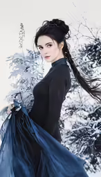 a woman wearing a long skirt with feathers on her shoulder
